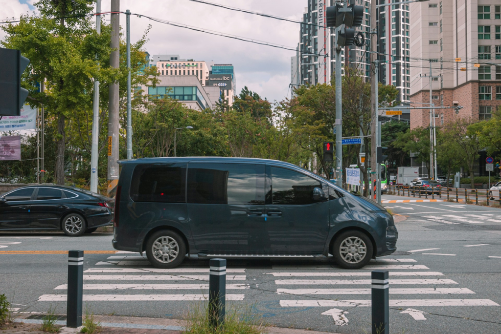 Dark minivan driving across a city crosswalk - Lead Grow Develop - Business, Technology, Personal Development Dark minivan driving across a city crosswalk