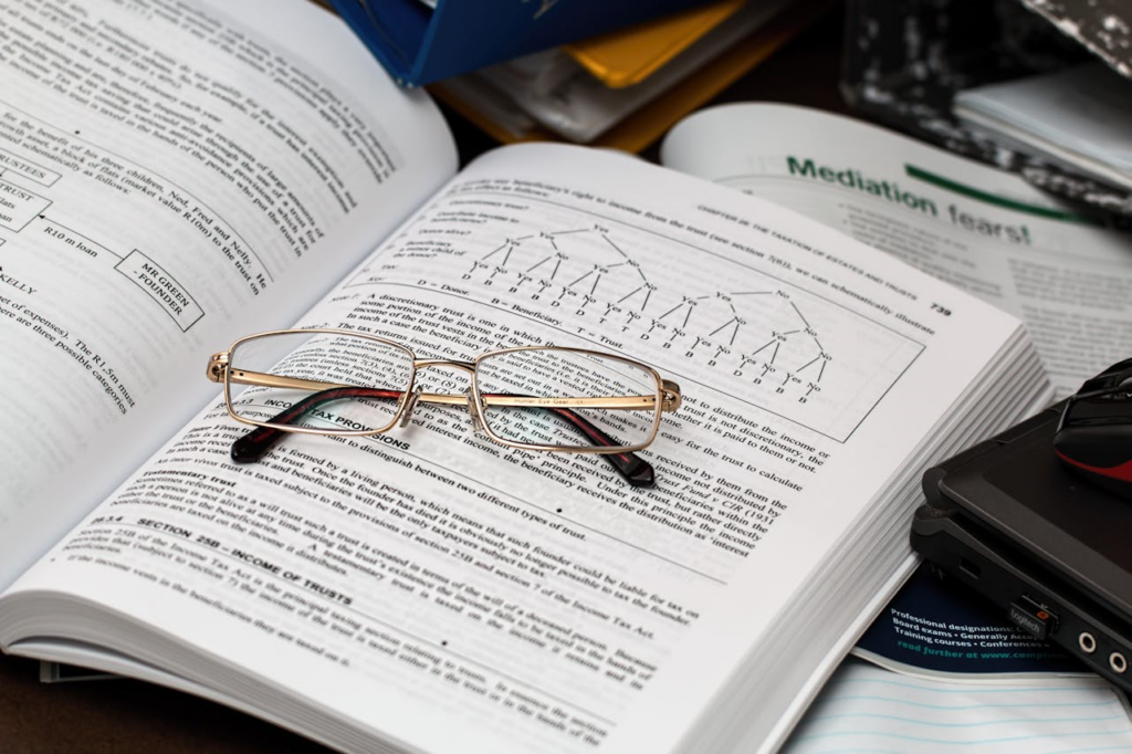 Eyeglasses on an Opened Book - Lead Grow Develop - Business, Technology, Personal Development Eyeglasses on an Opened Book