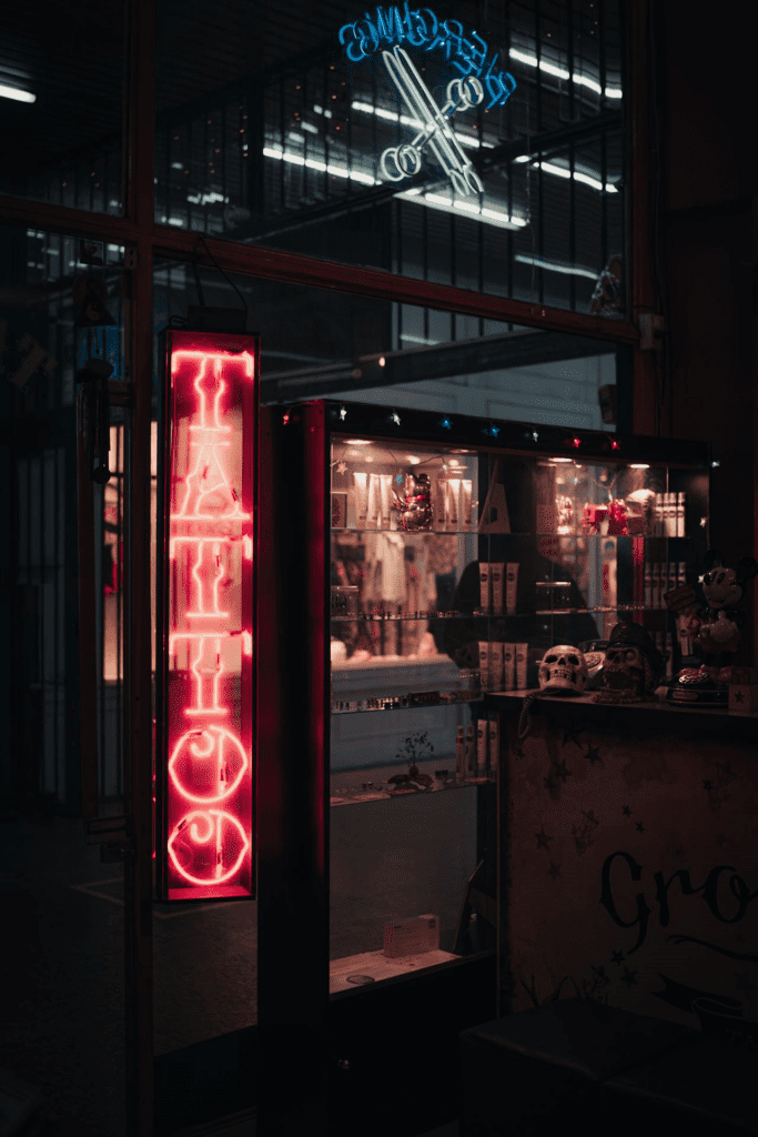 Neon Tattoo Shop Sign in Urban Setting