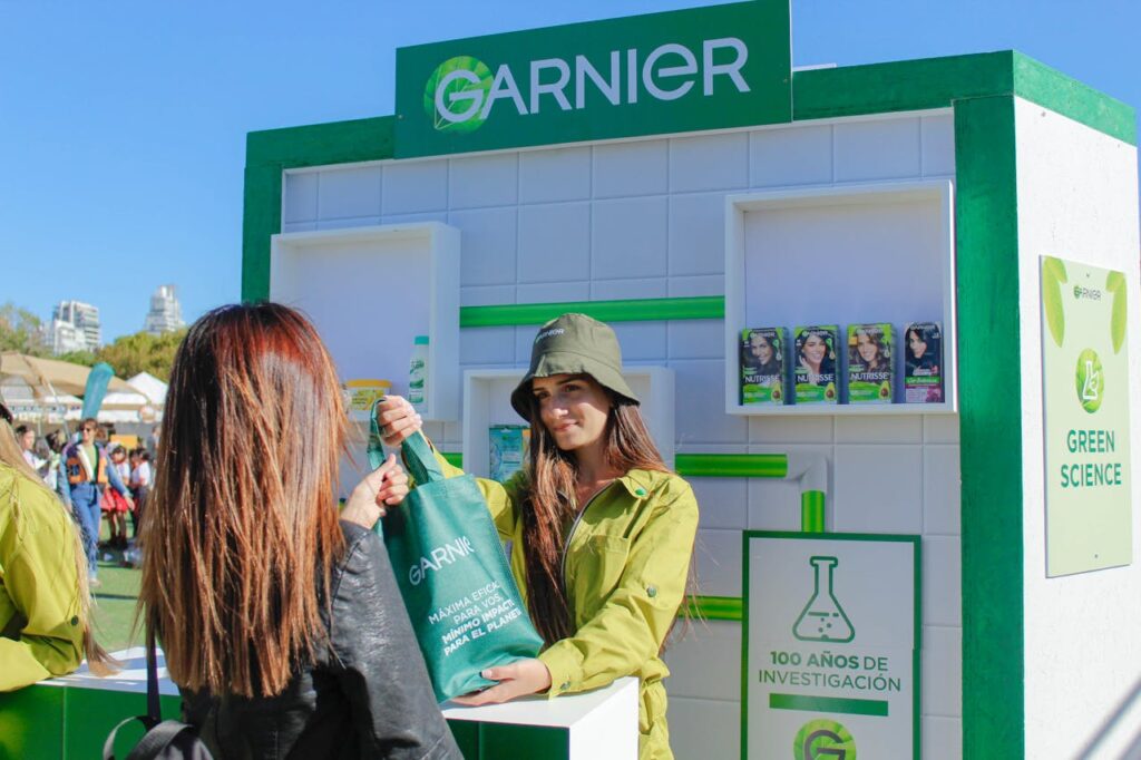 Garnier event with women distributing branded bags at an outdoor stall
