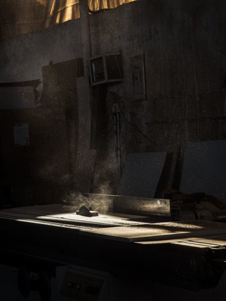 dramatic sunlit workshop with sawdust particles