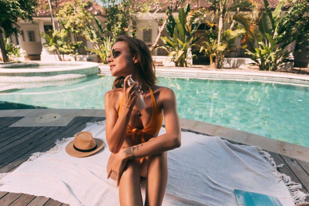 pexels-photo-8158589 - Lead Grow Develop - Business, Technology, Personal Development a woman in bikini spraying a skin care product