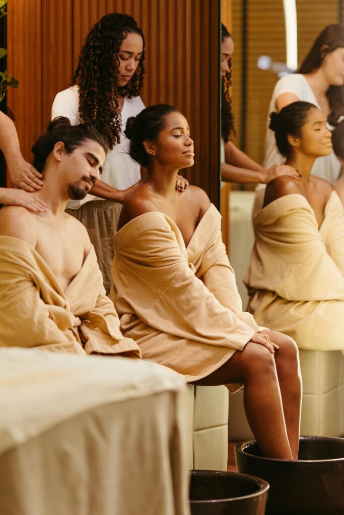 A serene spa scene featuring couples enjoying massages and foot baths