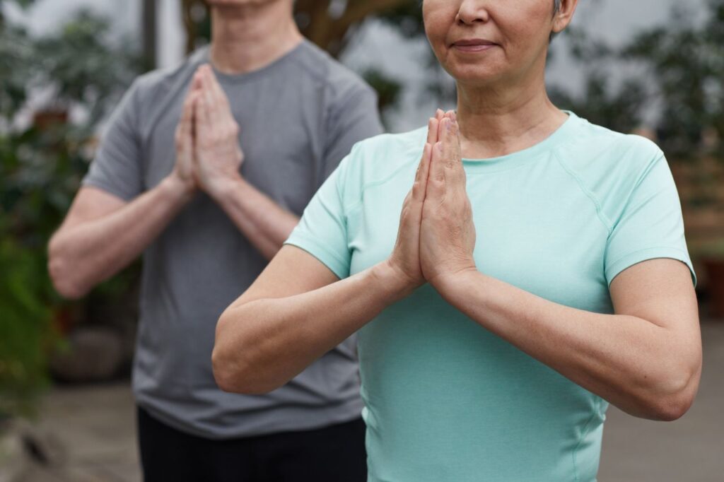 pexels-marcus-aurelius-6787500 - Lead Grow Develop - Business, Technology, Personal Development Senior couple in a meditative yoga pose outdoors, promoting wellness and a healthy lifestyle