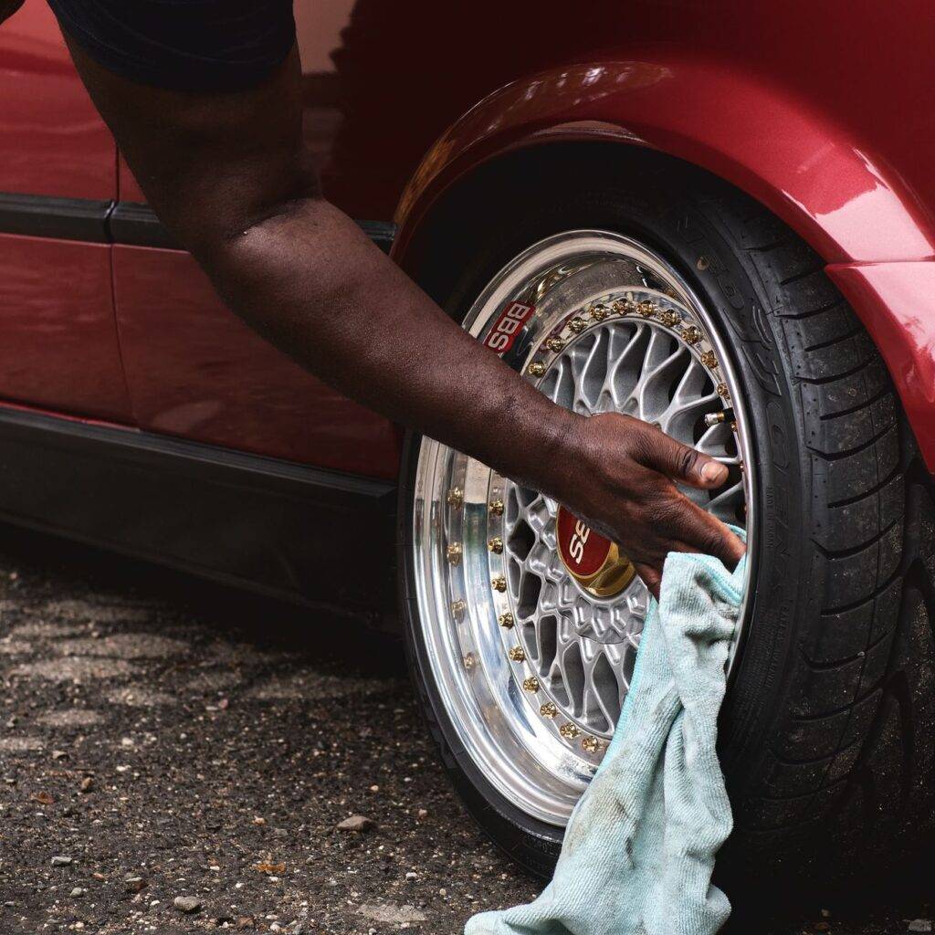 man cleaning wheel