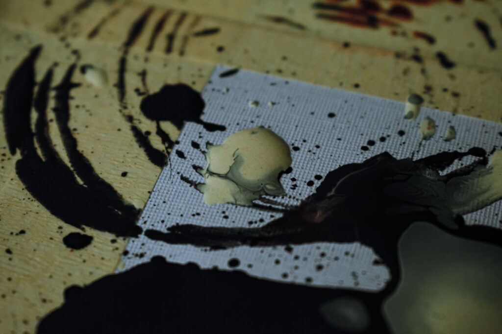 black paints spilled on table and forming circles