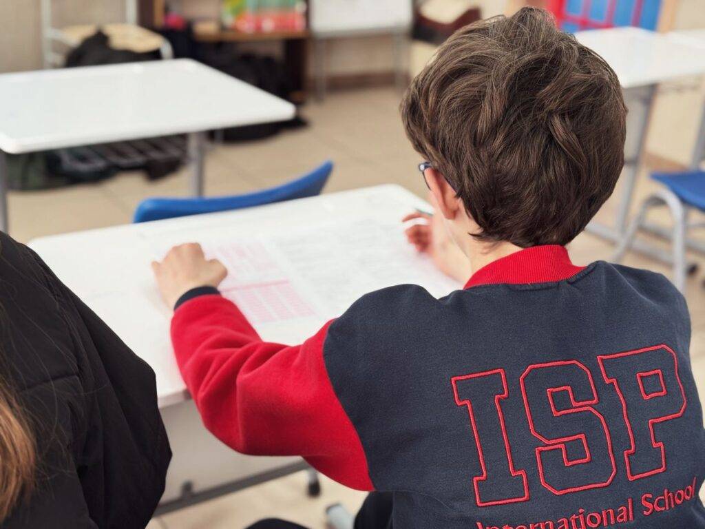A student engaged in learning at an international school desk