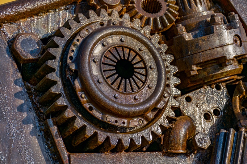 industrial diesel engines - Lead Grow Develop - Business, Technology, Personal Development Close-up of large rusted gears and a worn clutch inside a weathered mechanical assembly.