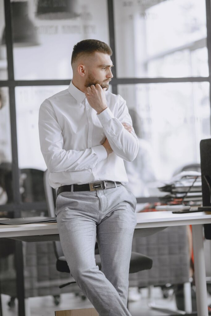 pexels-gustavo-fring-4872062 - Lead Grow Develop - Business, Technology, Personal Development Business professional in a bright office, pondering by the desk