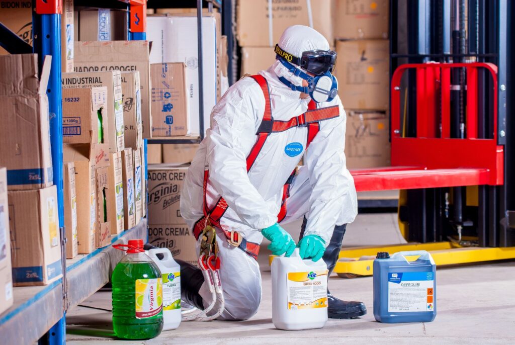 person wearing white suit holding white container
