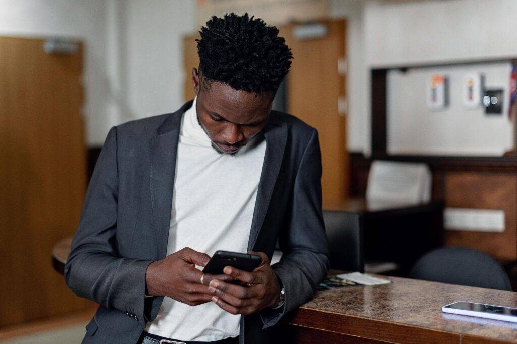 man looking at messages on mobile phone
https://www.pexels.com/photo/man-wearing-suit-jacket-holding-a-cellphone-8730937/
