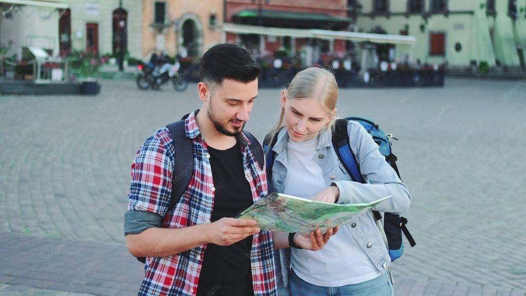 travel apps. couple travelling and looking at a map