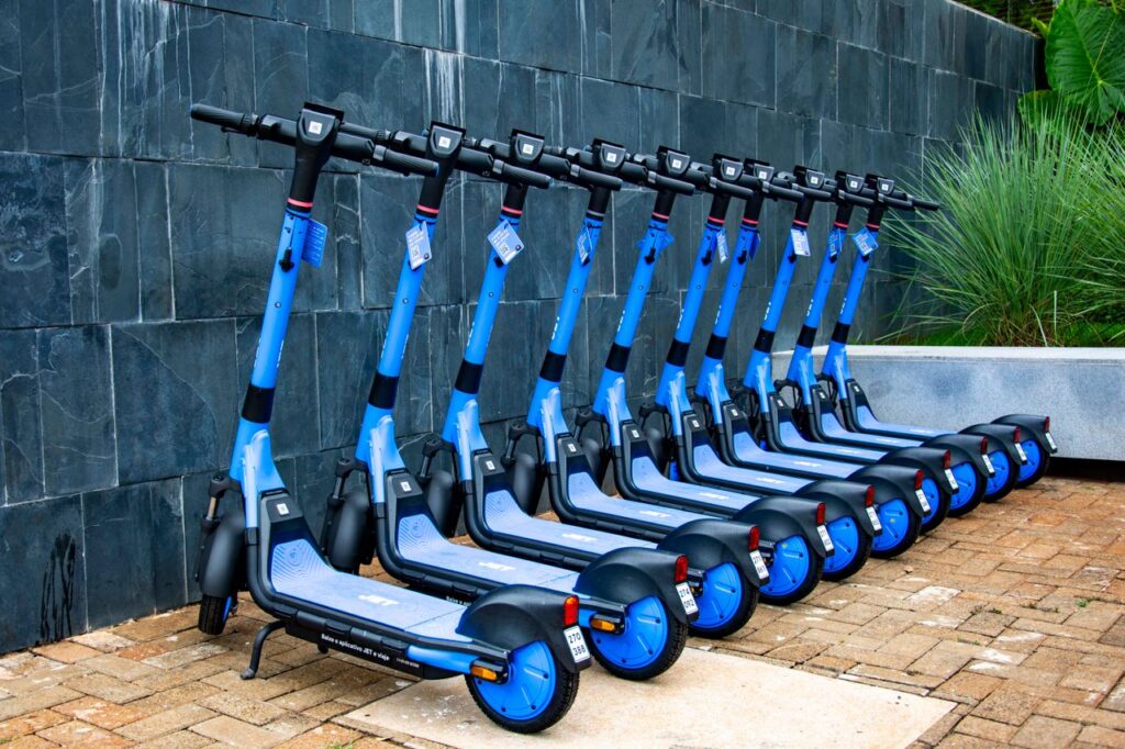 pexels-gaion-29766153 - Lead Grow Develop - Business, Technology, Personal Development Bright blue electric scooters neatly lined up against a wall in Londrina, Brazil