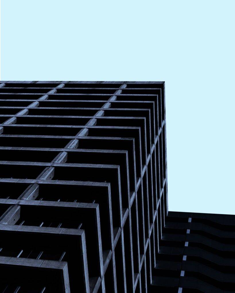 Low angle view of a modern minimalist building against a clear blue sky in Santiago