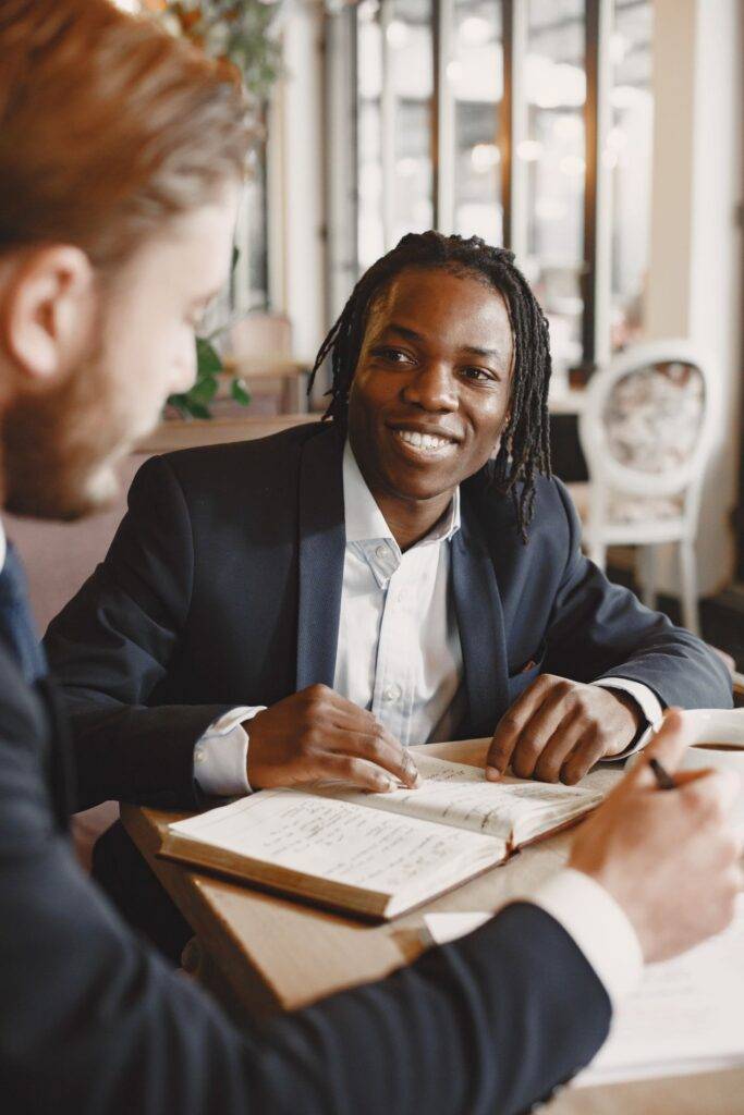 Two businessmen engaged in a productive meeting at a modern office table.