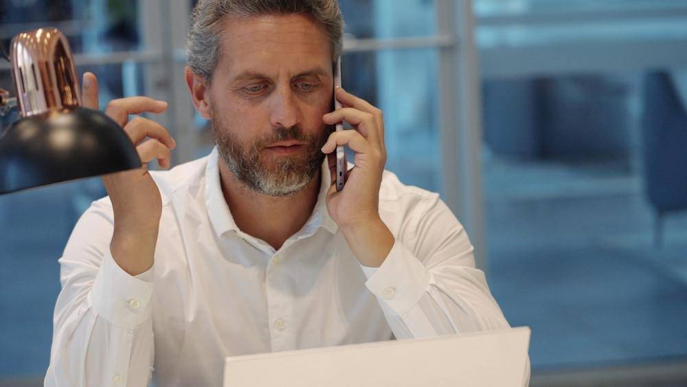 man communicating on the phone