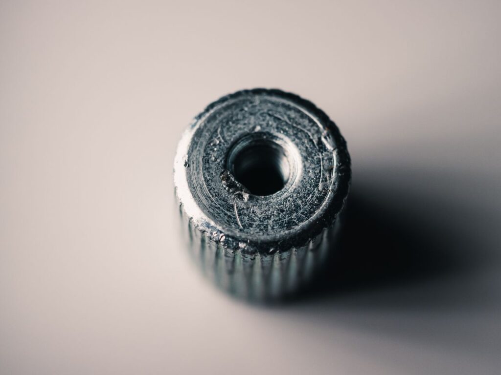 Detailed macro shot of a metal screw showing its textured surface and machining marks.